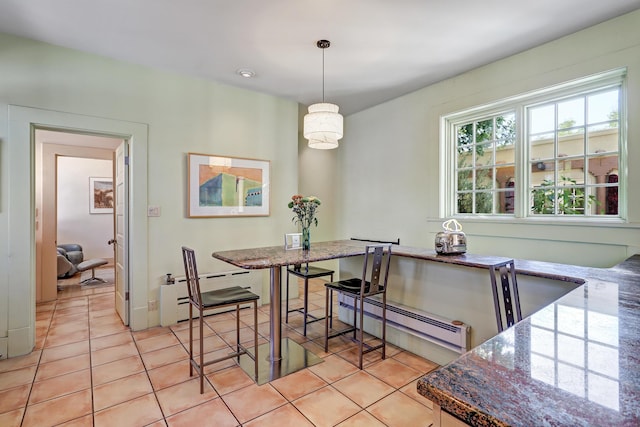 tiled dining space featuring a baseboard radiator