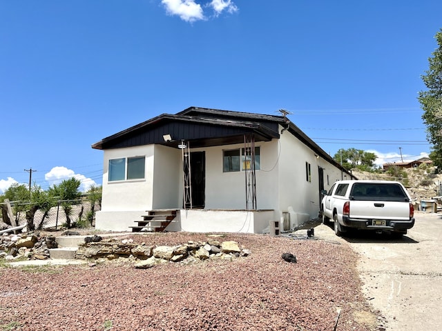 manufactured / mobile home with fence and stucco siding