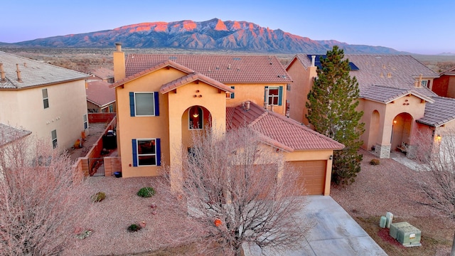 view of front of home featuring a mountain view and a garage