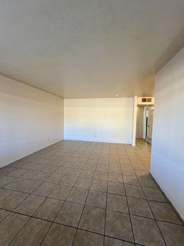 empty room featuring tile patterned floors