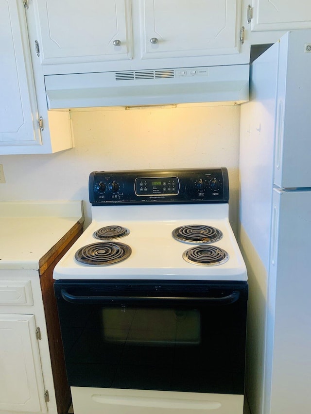 kitchen featuring white cabinets, white appliances, and extractor fan