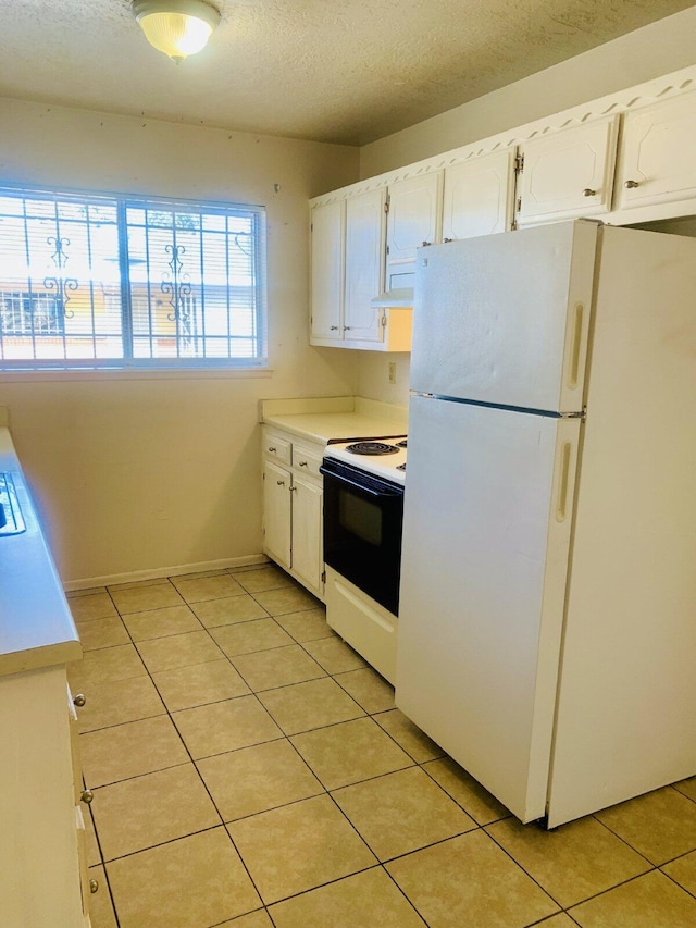 kitchen featuring light tile patterned flooring, a textured ceiling, white appliances, white cabinetry, and range hood