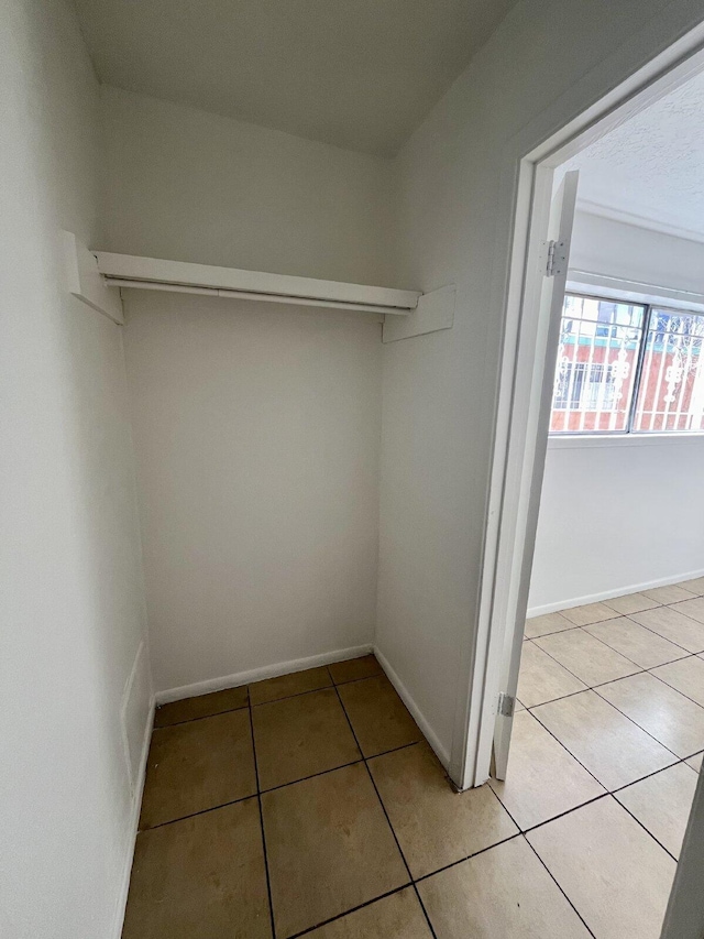 walk in closet featuring light tile patterned flooring