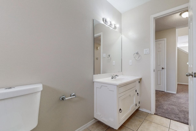 bathroom featuring tile patterned floors, vanity, and toilet