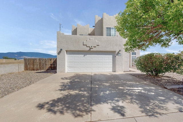 view of front facade with a mountain view and a garage