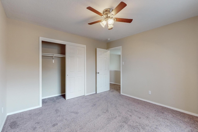 unfurnished bedroom featuring carpet floors, a closet, and ceiling fan