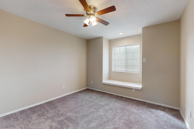 carpeted empty room featuring ceiling fan and a textured ceiling