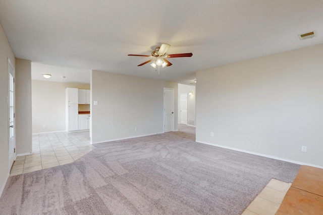 tiled empty room with ceiling fan