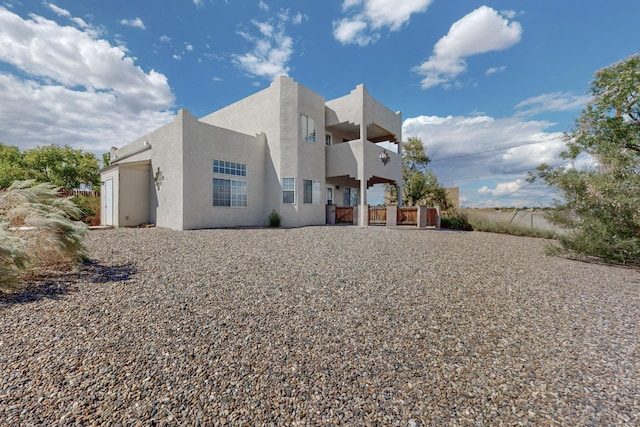 back of property featuring a balcony