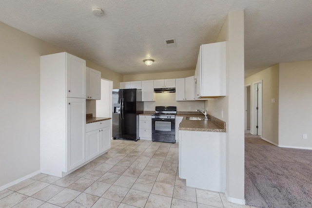 kitchen with black appliances, white cabinets, sink, and a textured ceiling