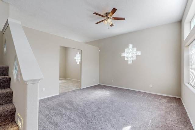 carpeted empty room featuring ceiling fan