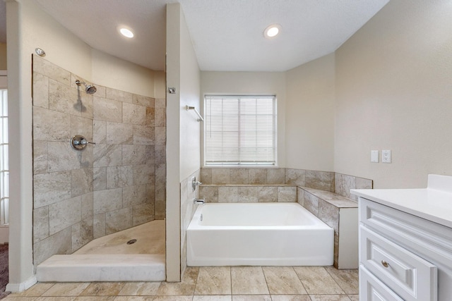 bathroom with tile patterned floors, vanity, and independent shower and bath