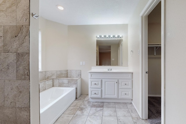 bathroom with a bathing tub and vanity