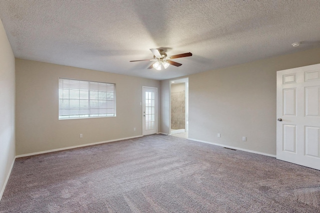 carpeted spare room with ceiling fan and a textured ceiling