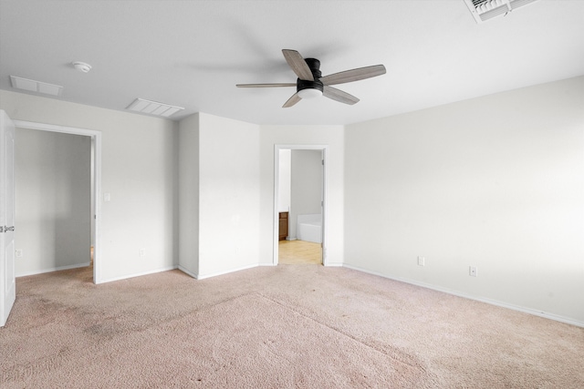 unfurnished room with ceiling fan and light carpet