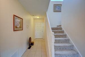 stairs featuring tile patterned flooring