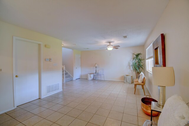 tiled spare room featuring ceiling fan