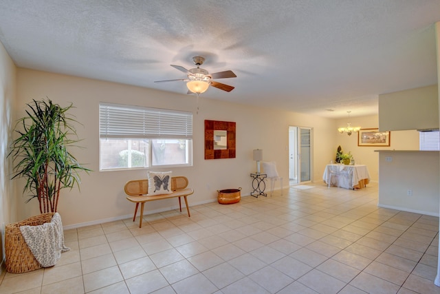 tiled empty room with ceiling fan with notable chandelier and a textured ceiling