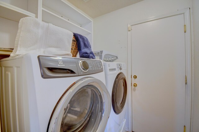 washroom featuring washer and dryer