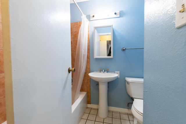 bathroom with tile patterned floors, shower / bath combo, and toilet