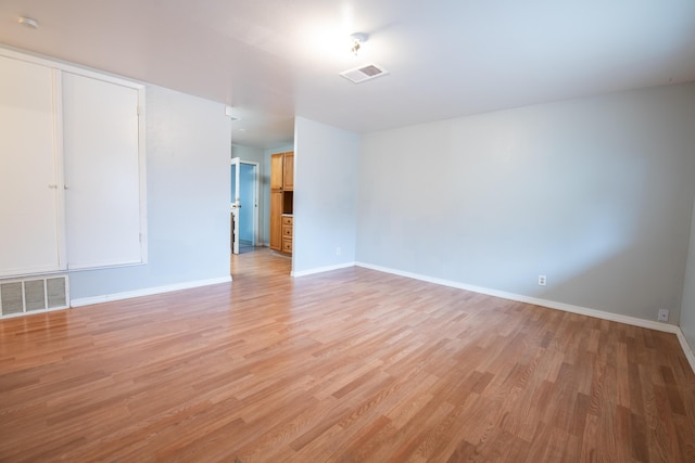 spare room featuring light wood-type flooring