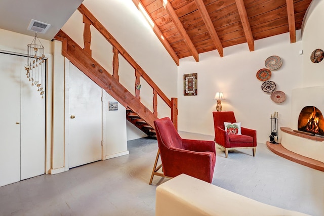 living room with a chandelier, lofted ceiling with beams, concrete flooring, and wooden ceiling