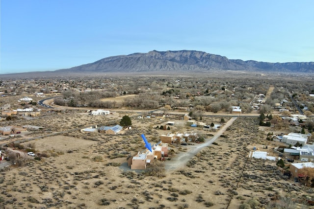 drone / aerial view featuring a mountain view and view of desert