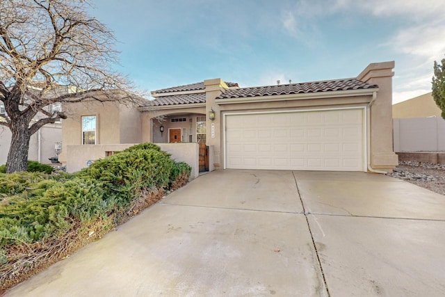 mediterranean / spanish house featuring a garage