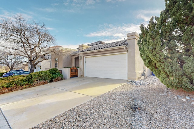 mediterranean / spanish home featuring a garage