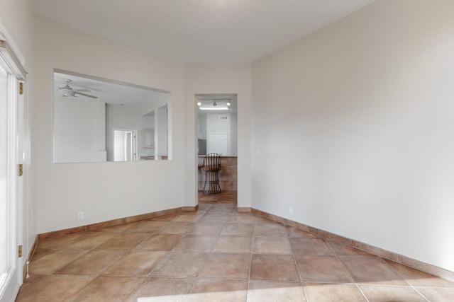 unfurnished room with ceiling fan and light tile patterned floors