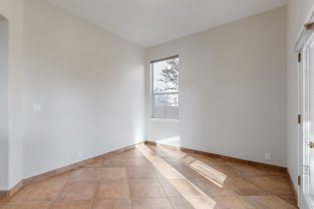 spare room featuring light tile patterned floors