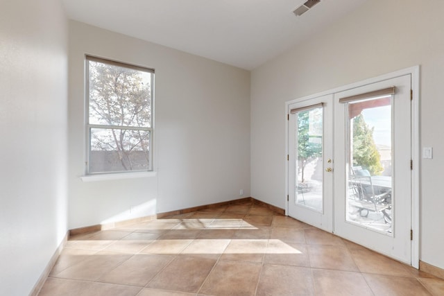 doorway to outside featuring french doors and light tile patterned flooring