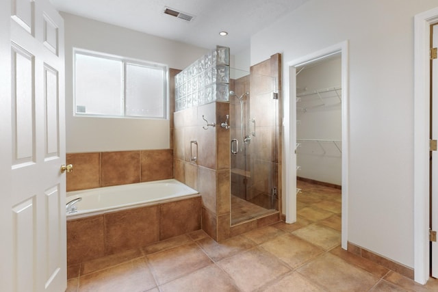 bathroom with tile patterned floors and plus walk in shower