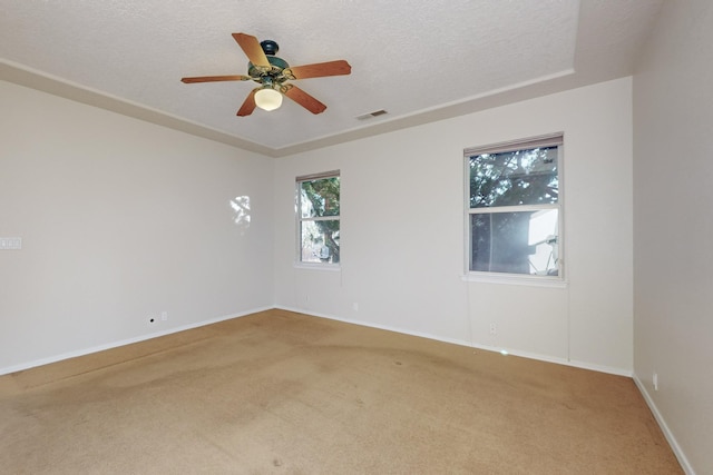 carpeted empty room featuring a textured ceiling and ceiling fan