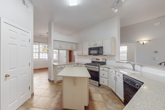 kitchen featuring black appliances, a center island, light stone counters, and sink