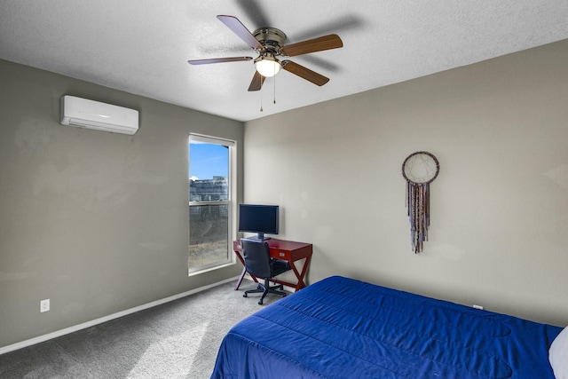 carpeted bedroom with baseboards, a textured ceiling, a ceiling fan, and a wall unit AC