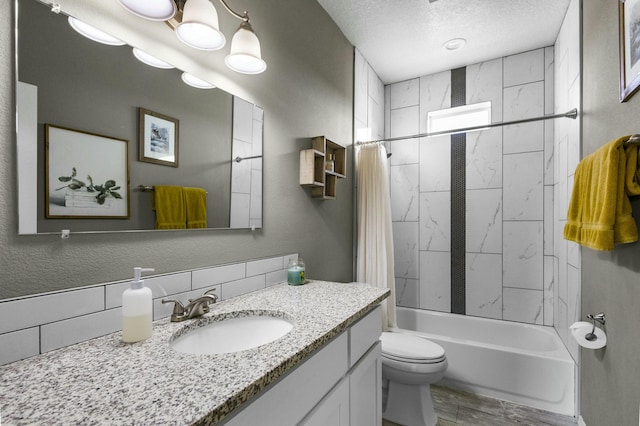 full bath featuring vanity, shower / bath combination with curtain, a textured ceiling, toilet, and a textured wall