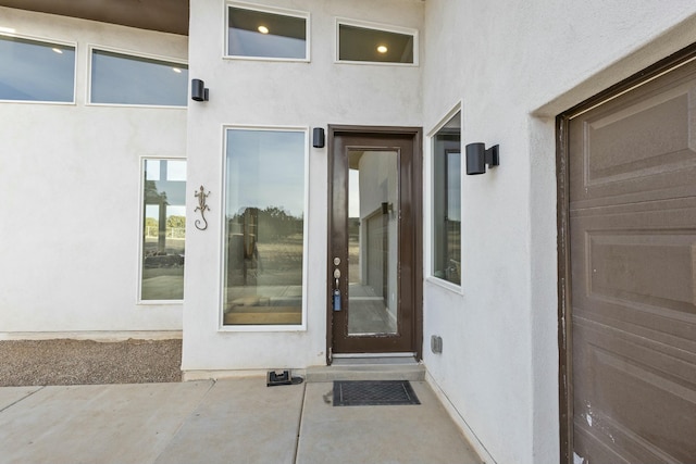 property entrance featuring stucco siding