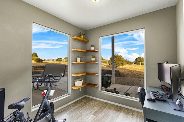 office area featuring baseboards and wood finished floors