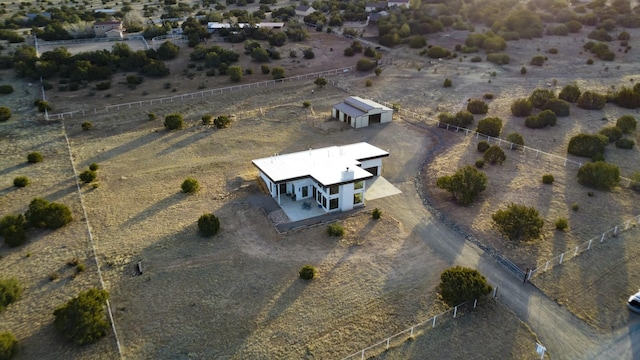 bird's eye view with view of desert and a rural view