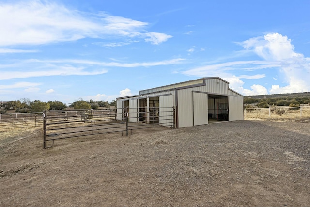 view of outdoor structure featuring an outbuilding, a rural view, and an exterior structure