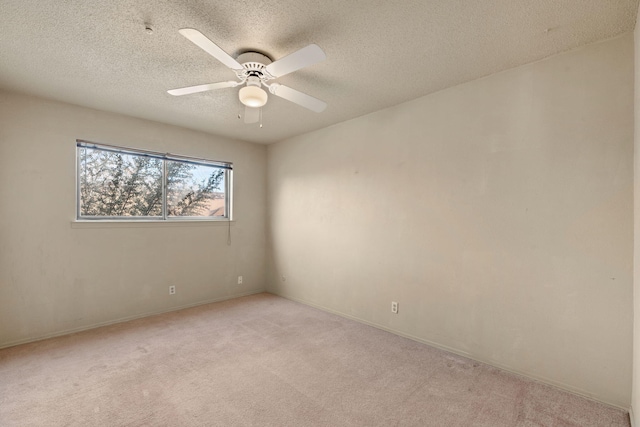 empty room with light carpet, a textured ceiling, and ceiling fan