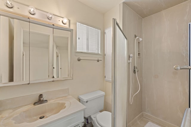 bathroom featuring vanity, toilet, and walk in shower