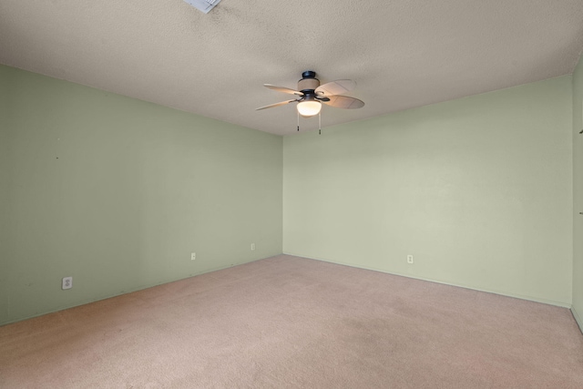 unfurnished room with carpet flooring, ceiling fan, and a textured ceiling