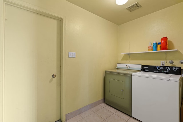 washroom featuring independent washer and dryer and light tile patterned flooring