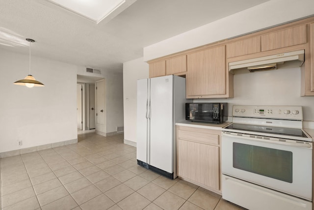 kitchen featuring light brown cabinetry, white appliances, decorative light fixtures, and light tile patterned floors