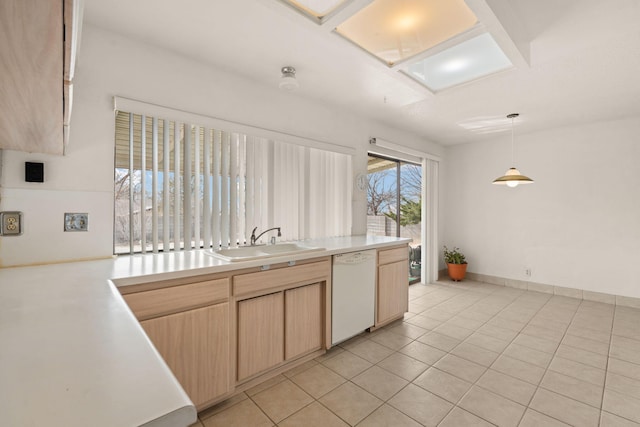 kitchen with sink, white dishwasher, pendant lighting, light brown cabinetry, and light tile patterned floors