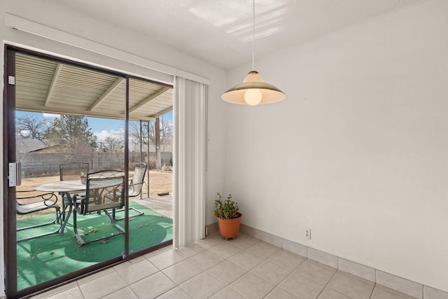 interior space with light tile patterned floors and a textured ceiling