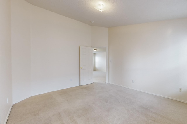 empty room with light colored carpet