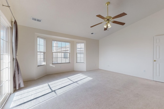 unfurnished room featuring ceiling fan, light colored carpet, and vaulted ceiling